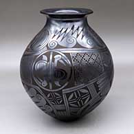 A black on black jar with a rolled lip and a two-panel medallion, bird, spiral and geometric design
 by Tina Esperanza of Mata Ortiz and Casas Grandes