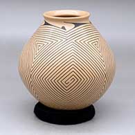 A black-on-tan jar with a flared lip and a four-panel angular spiral geometric design
 by Pilo Mora of Mata Ortiz and Casas Grandes