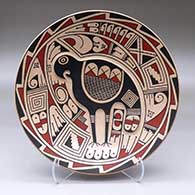 A shallow polychrome bowl decorated inside with a lightly carved quail and geometric design
 by Jose Andres Villalba of Mata Ortiz and Casas Grandes