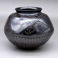 A black on black jar with a rolled lip, faceted above the shoulder and decorated top-to-bottom with a geometric design
 by Macario Ortiz of Mata Ortiz and Casas Grandes