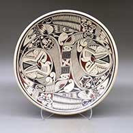 A large, shallow polychrome bowl decorated on top with a bird, butterfly and geometric design
 by Cesar Dominguez of Mata Ortiz and Casas Grandes