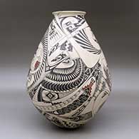 A large polychrome jar with a rolled lip and decorated with a bird element, fish and geometric design, click or tap to see a larger version