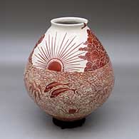 A red on white jar decorated with a sgraffito design of nature and wildlife at the beach
 by Leonel Lopez Sr of Mata Ortiz and Casas Grandes