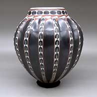 A polychrome melon jar with sixteen repousse ribs and a painted geometric design, click or tap to see a larger version