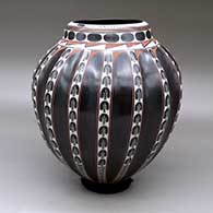 A polychrome melon jar with sixteen repousse ribs and a painted geometric design
 by Leonel Quezada of Mata Ortiz and Casas Grandes