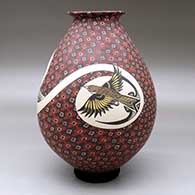 A polychrome jar with a rolled lip and decorated with a bird and geometric design, click or tap to see a larger version