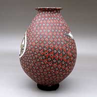 A polychrome jar with a rolled lip and decorated with a bird and geometric design, click or tap to see a larger version