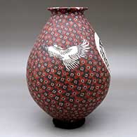 A polychrome jar with a rolled lip and decorated with a bird and geometric design, click or tap to see a larger version
