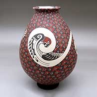 A polychrome jar with a rolled lip and decorated with a bird and geometric design
 by Manuel Rodriguez of Mata Ortiz and Casas Grandes
