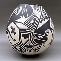 A large black on tan jar with a geometric cut opening and decorated with a variety of Mimbres wildlife, humans and geometric designs, click or tap to see a larger version