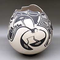 A large black on tan jar with a geometric cut opening and decorated with a variety of Mimbres wildlife, humans and geometric designs
 by Martin Cota of Mata Ortiz and Casas Grandes