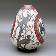 A polychrome jar decorated with a sgraffito and slipped four panel wildlife, bird, branch, leaf and geometric design, click or tap to see a larger version