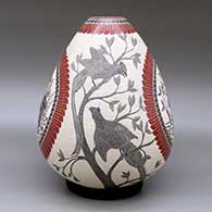 A polychrome jar decorated with a sgraffito and slipped four panel wildlife, bird, branch, leaf and geometric design, click or tap to see a larger version