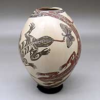 A polychrome jar decorated with a lizard, butterfly and geometric design
 by Manuel Rodriguez of Mata Ortiz and Casas Grandes