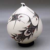 A polychrome seed pot with a sculpted opening and decorated in the Quezada style with a flowing geometric design
 by Mauro Quezada of Mata Ortiz and Casas Grandes