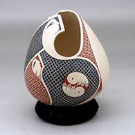 A polychrome jar with a geometric cut opening and decorated with a tiny square and geometric design
 by Elias Pena of Mata Ortiz and Casas Grandes