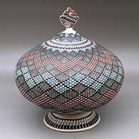 A lidded polychrome jar decorated with a fine line and geometric design, plus a custom stand
 by Yolanda Soto of Mata Ortiz and Casas Grandes