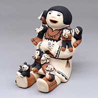 A sitting grandmother storyteller figure with seven children and a cat
 by Maria P Romero of Cochiti