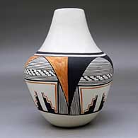 A polychrome jar decorated with a four-panel geometric design around the body, click or tap to see a larger version
