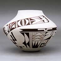 A polychrome jar decorated with a two-panel bird element and geometric design, click or tap to see a larger version