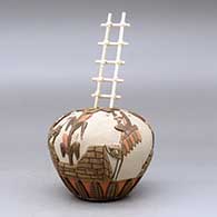 A polychrome seed pot carved and painted with a kachina, corn plant and pueblo geometric design, plus a kiva ladder, click or tap to see a larger version
