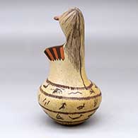 A polychrome jar with a kachina mask overlay and decorated with a rock art, bird element and geometric design, click or tap to see a larger version