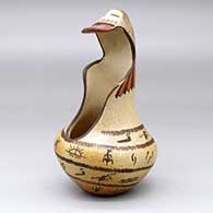 A polychrome jar with a kachina mask overlay and decorated with a rock art, bird element and geometric design, click or tap to see a larger version