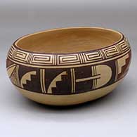 An oval polychrome bowl polished inside and decorated with a band of geometric design around the body
 by Pauline Setalla of Hopi
