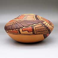 A polychrome seed pot jar decorated with a lightly carved and painted eagle dancer, sun kachina, bird element and geometric design, click or tap to see a larger version