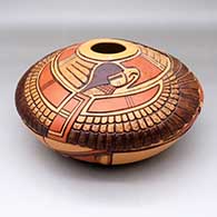 A polychrome seed pot jar decorated with a lightly carved and painted eagle dancer, sun kachina, bird element and geometric design
 by Thomas Polacca of Hopi