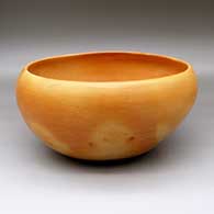 A large Jeddito black on yellow bowl decorated inside with a four-panel geometric design, and outside with fire clouds, click or tap to see a larger version