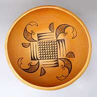 A large Jeddito black on yellow bowl decorated inside with a four-panel geometric design, and outside with fire clouds
 by Marcella Kahe of Hopi