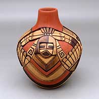 Click for a larger view A polychrome jar decorated with a carved, sgraffito and painted four panel kachina dancer, bird element, feather and geometric design
by Thomas Polacca of Hopi