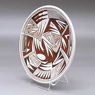 A polychrome plate decorated with a geometric design, click or tap to see a larger version