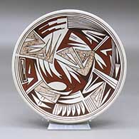 A polychrome plate decorated with a geometric design
 by Maynard Navasie of Hopi