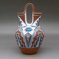 A polychrome wedding vase with two pieces of inlaid turquoise and decorated with a four-panel geometric design, click or tap to see a larger version