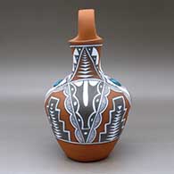 A polychrome wedding vase with two pieces of inlaid turquoise and decorated with a four-panel geometric design, click or tap to see a larger version