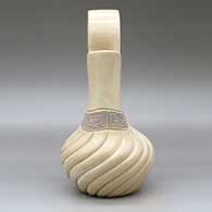 A beige wedding vase with a swirl melon-carved body and a band of black on beige scrolls geometric design around the neck, click or tap to see a larger version