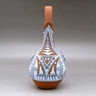 A polychrome wedding vase with two pieces of inlaid turquoise and decorated with a geometric design, click or tap to see a larger version