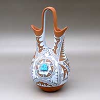 A polychrome wedding vase with two pieces of inlaid turquoise and decorated with a geometric design
 by Mary Small of Jemez
