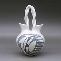 A grey on white wedding vase with a twisted bridge and decorated with a two-panel feather and geometric design, click or tap to see a larger version
