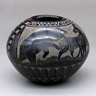 A black bowl with a sgraffito bear, antelope, feather and geometric design
 by Red Starr of NonPueblo
