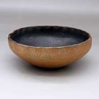 A golden micaceous bowl with fire clouds, a pie crust rim and a black interior
 by Sheldon Nunez Velarde of Jicarilla Apache
