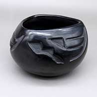Black bowl with a triangular opening and a three-panel carved geometric design
 by Frances Naranjo of Santa Clara