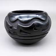Black bowl with a carved avanyu design
 by Stella Chavarria of Santa Clara