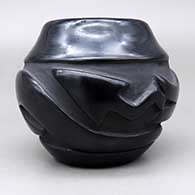 Small black jar with a carved avanyu design, click or tap to see a larger version