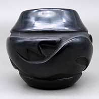 Small black jar with a carved avanyu design, click or tap to see a larger version