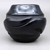 Small black jar with a carved avanyu design, click or tap to see a larger version