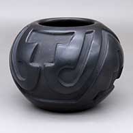 A black jar carved with a four-panel geometric design
 by Belen Tapia of Santa Clara