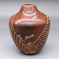 A sepia jar decorated with a sgraffito lizard and geometric design
 by Bernice Naranjo of Taos